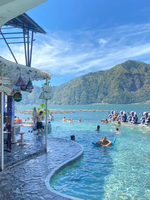 Batur Natural Hotspring Bali at Toya Devasya is a serene geothermal retreat by the edge of Lake Batur, offering warm volcanic pools with stunning views of Mount Batur. Relax in mineral-rich waters surrounded by Bali’s breathtaking mountain landscape. A highlight of the Kintamani tour with BaliWondersTour, this hot spring experience blends nature, wellness, and unforgettable scenery. 